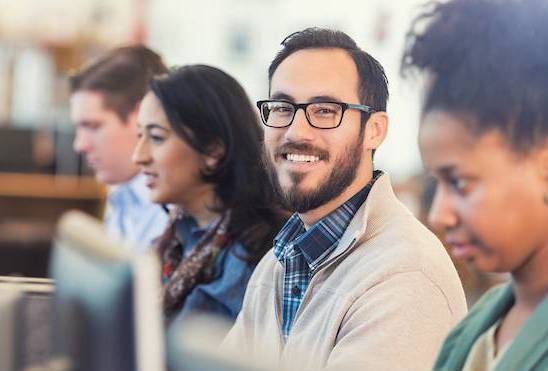 Man smiling sitting at computer